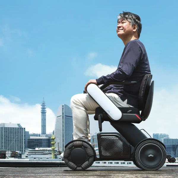 A man sitting on top of a scooter.