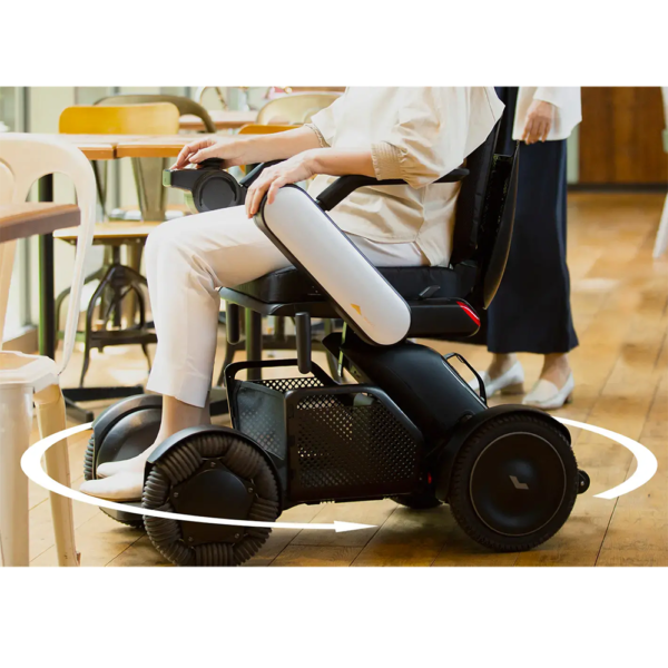 A person riding an electric scooter in a restaurant.