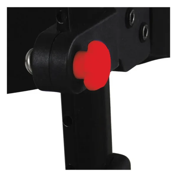 A red button is on the side of a black object.