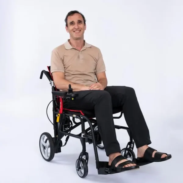 A man sitting in a wheelchair with his feet on the ground.