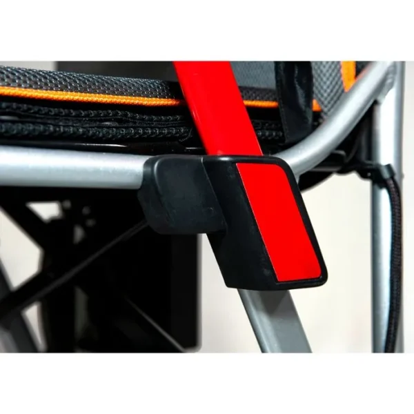 A red and black seat belt hanging from the side of a chair.