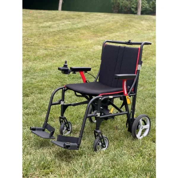 A wheelchair is sitting in the grass.