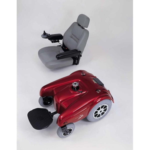 A red scooter and seat on the floor.