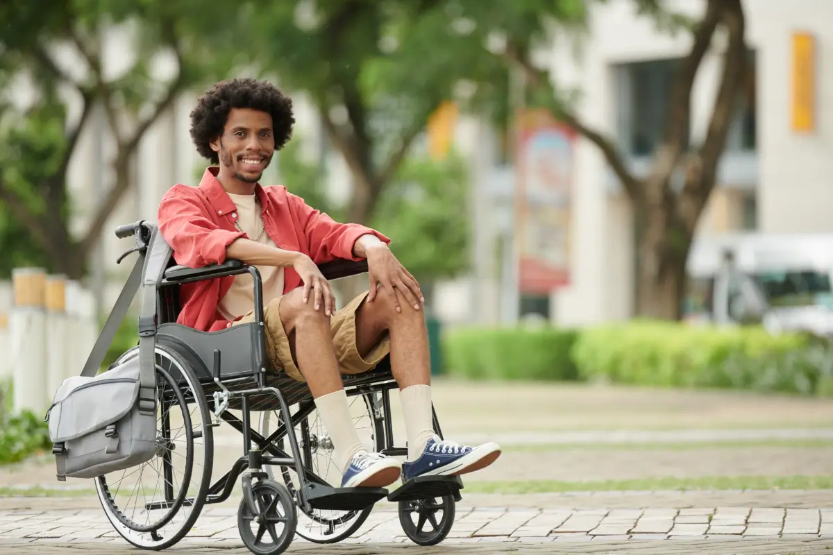 A man in a wheelchair on the sidewalk.