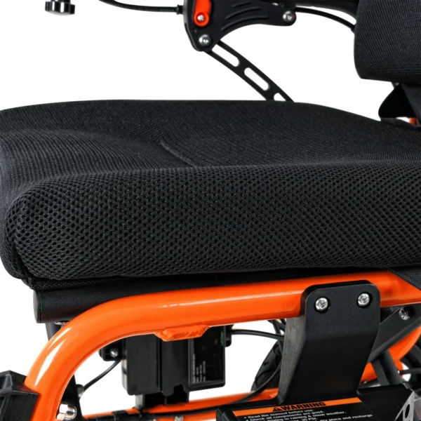 A close up of the seat on an orange scooter