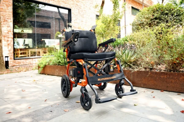 A wheelchair is parked on the sidewalk outside.