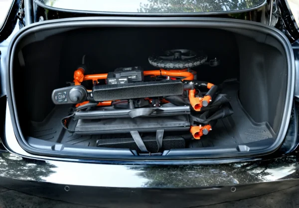 A car trunk with some scooters in it