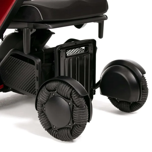 A close up of the wheels on a red and black scooter.