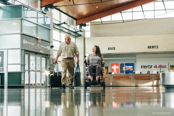 A man and woman walking through an airport terminal.