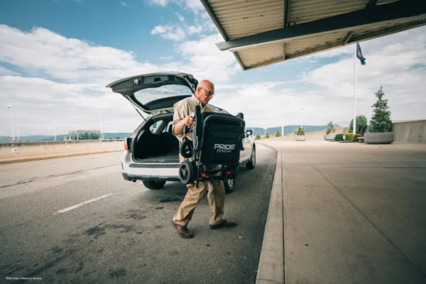 A man is pulling luggage out of the trunk.