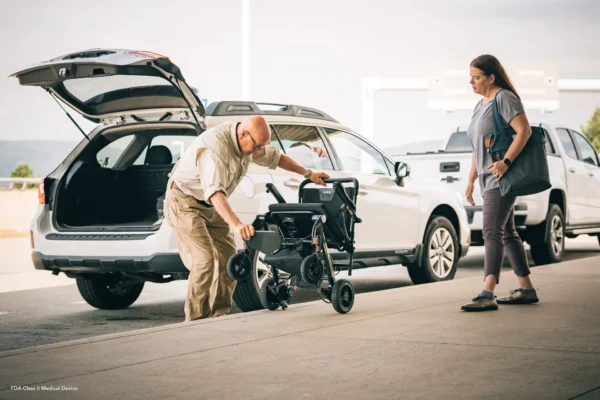 A man and woman looking at the back of an suv.