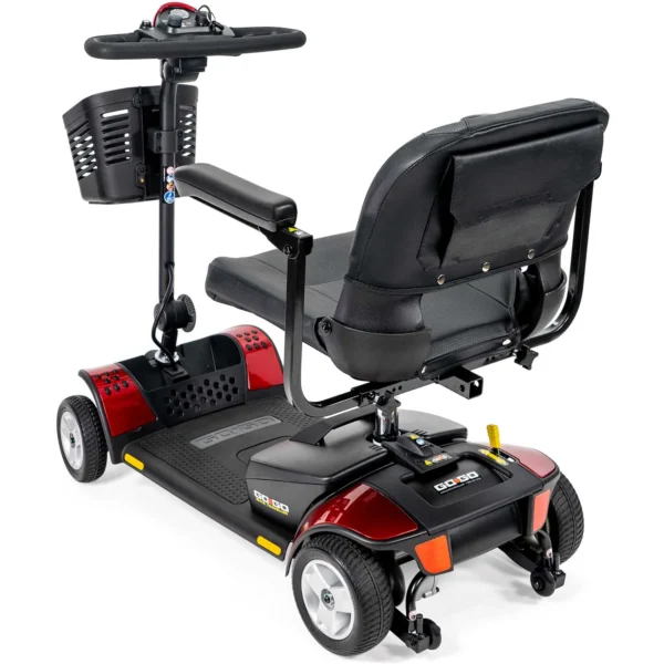 A red scooter with the seat up.