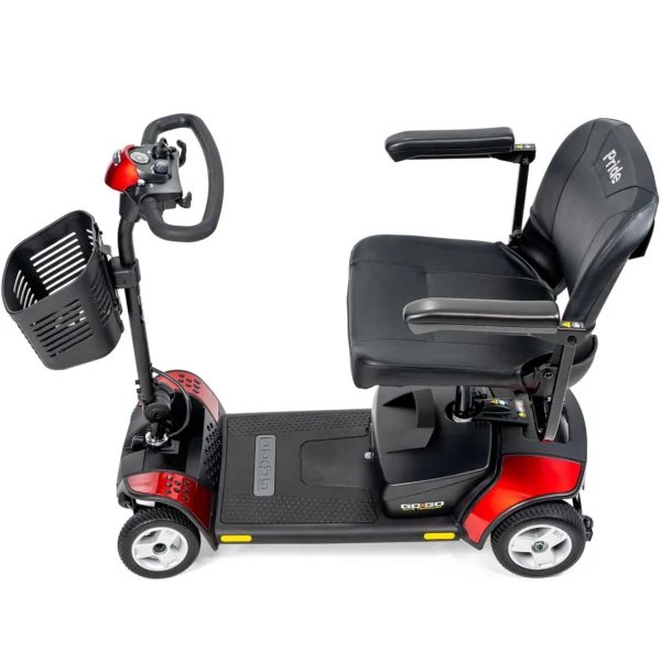 A red scooter with the seat up and steering wheel on it.