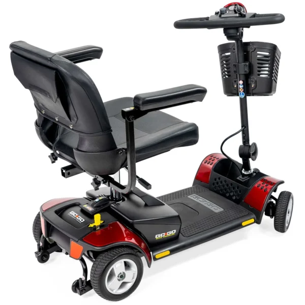 A red scooter with a seat up and the back of it.