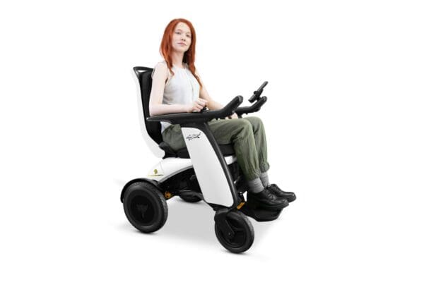 A woman sitting in a white wheelchair with wheels.