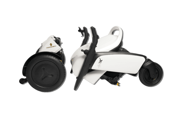 A white scooter with black wheels and a green background